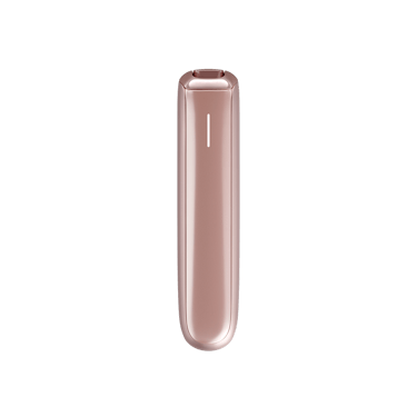 Ploom AURA Rose Gold device on a table during a coffee break.